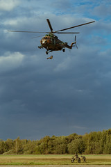 Fototapeta na wymiar Landing of special forces on a rope from a Mi-8 helicopter