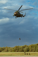 Fototapeta na wymiar Landing of special forces on a rope from a Mi-8 helicopter