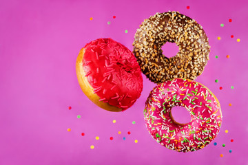 Flying multicolored Donuts with sprinkles