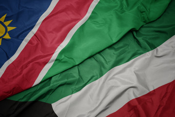waving colorful flag of kuwait and national flag of namibia.