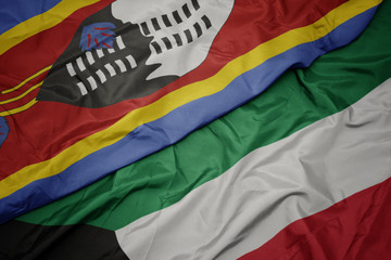 waving colorful flag of kuwait and national flag of swaziland.