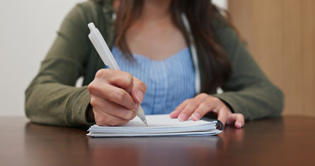 Fototapeta na wymiar Woman write on notebook at home