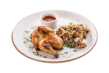 Half chicken tobacco with cooked buckwheat with mushroom and tomato sauce isolated on white background