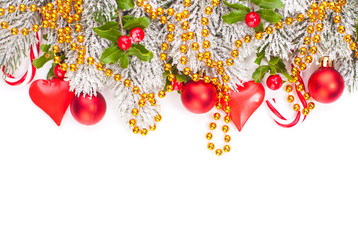 Christmas composition with red holly berries, glass baubles, golden garland and green Xmas tree...