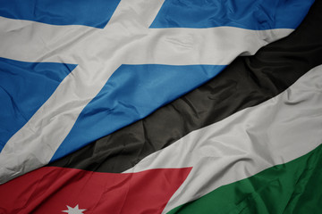 waving colorful flag of jordan and national flag of scotland.