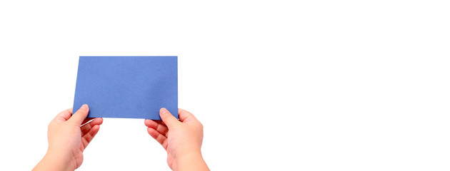 The hand is holding the envelope.