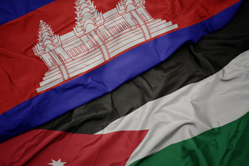 waving colorful flag of jordan and national flag of cambodia.