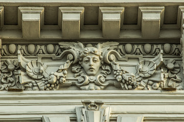 textured bas-relief on the facade of a building made of gray stone