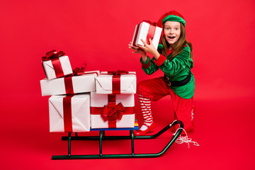 Full length body size view of nice attractive cheerful cheery funny pre-teen elf carrying guessing...