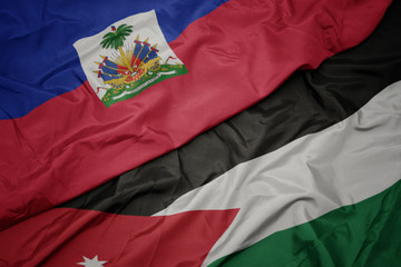 waving colorful flag of jordan and national flag of haiti