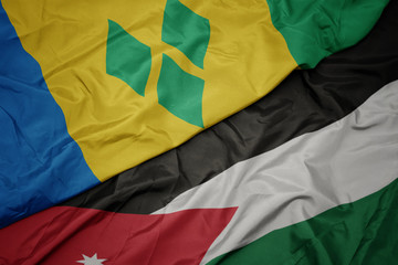 waving colorful flag of jordan and national flag of saint vincent and the grenadines.