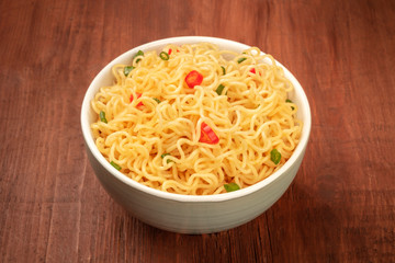 A bowl of noodles on a dark rustic wooden background