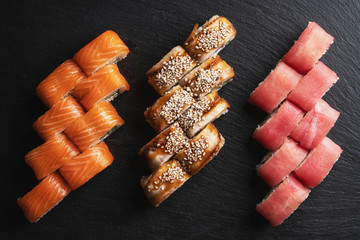 Japanese menu. Sushi roll on a black background.