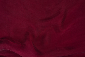 Soft smooth burgundy silk fabric background. Fabric texture. - obrazy, fototapety, plakaty