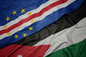 waving colorful flag of jordan and national flag of cape verde.