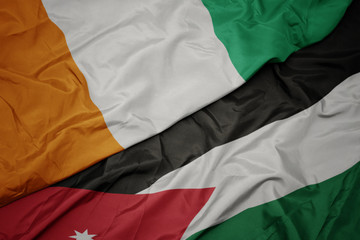 waving colorful flag of jordan and national flag of cote divoire.