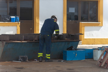 Fototapeta na wymiar Worker working on ship repairing yard