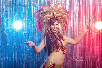 Carnival, dancer and holiday concept - Beauty brunette woman in cabaret suit and headdress with...