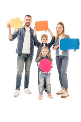 full length view of smiling family in jeans holding speech bubbles isolated on white