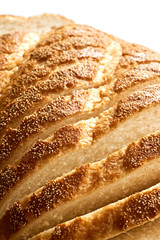 Slices of bread. Extreme closeup of freshly baked white sliced country bread with a crispy crust for use as a bakery background.. Vertical image an isolated on top for copy space.