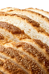 Slices of bread. Extreme closeup of freshly baked white sliced country bread with a crispy crust for use as a bakery background.. Vertical image an isolated on top for copy space.
