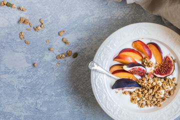 Healthy breakfast with granola cereals and fresh fruits, close-up flat lay seen from above