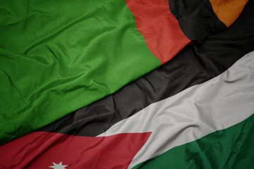 waving colorful flag of jordan and national flag of zambia.