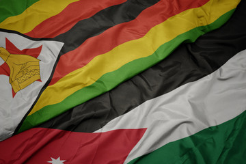 waving colorful flag of jordan and national flag of zimbabwe.