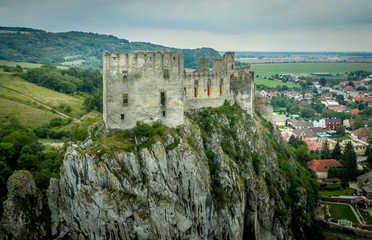 Obraz premium Aerial view of medieval Beckov castle with inner and outer courtyard, cannon tower, castle gate, chapel in Slovakia 