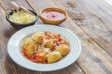 gnocchi stuffed with pesto with homemade tomato sauce and cheese