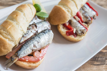 Sardines sandwich with tomato, lettuce, pepper