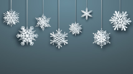 Christmas large complex paper hanging snowflakes on gray background