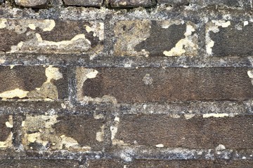 Detailed view on a weathered brick wall texture in high resolution close up