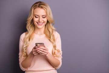 Fototapeta premium Photo of pretty addicted lady holding telephone in arms checking likes and subscribers wear casual pullover isolated grey color background