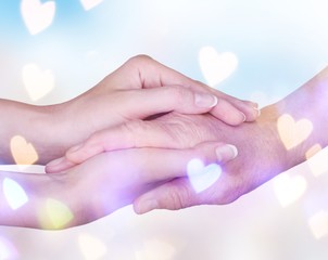 Hands of the old man and a young woman. close up.
