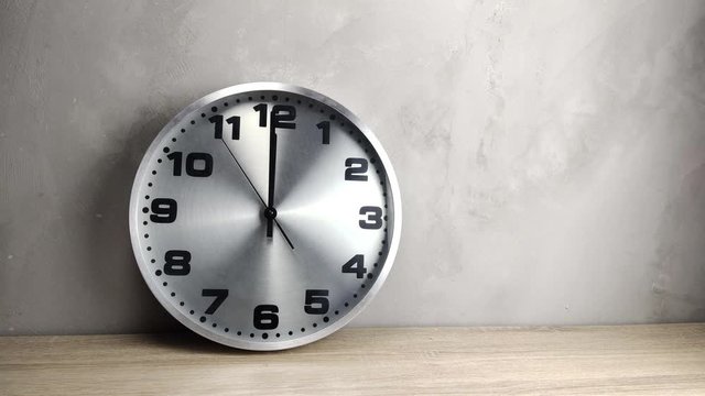 silver clock on wooden table Twelve o'clock