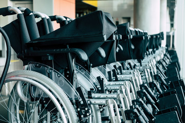 Group of parked wheel chairs at the airport or station for diversity ability people to help them to travel on the airplane flight