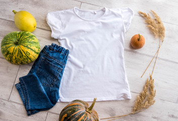 T-Shirt Mockup on a White Wooden Background with pumpkins