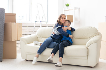 Cute single mom and little boy son relaxing after the move. The concept of housewarming mortgage and the joy of new housing.