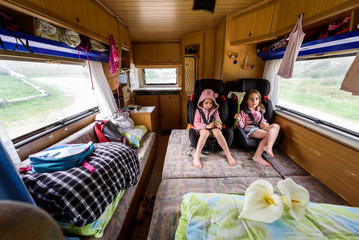 Children strapped in children safety seats when driving in motorhome.