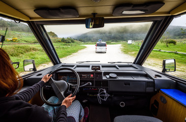 Driving motorhome or campervan on the road outdoors in nature.