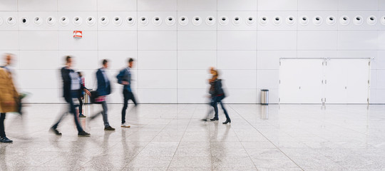crowd of people walking at a trade fair