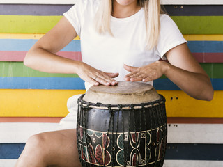 Young woman playing yuker drum