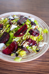 Homemade Healthy Salad with Beetroot, Goat Cheese, Pine Nuts and Balsamic Cream