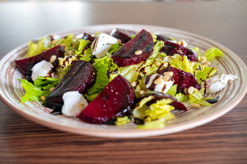 Homemade Healthy Salad with Beetroot, Goat Cheese, Pine Nuts and Balsamic Cream