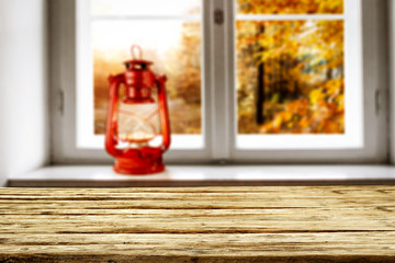 blurred autumn window background and desk of free space for your decoration. 