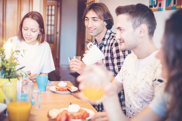 Group of friends having breakfast together at home, friendship chatting offline