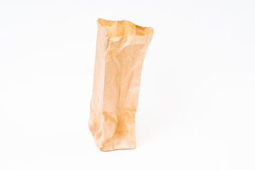 Crumpled brown paper bag on white background