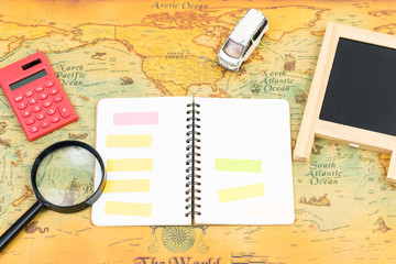 Blank notebook with accessory on world map. travel business concept