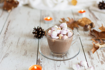 Obraz na płótnie Canvas Hot chocolate cacao drink with marshmallows and cinnamon on wooden background.